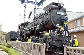 Steam locomotive brought back to railway park in western Japan