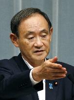 Suga shows skepticism over Koike's roles