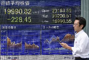 Nikkei drops below 20,000 as strong yen, Greece fears rattle market