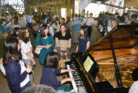 Former students sing before gymnasium is torn down