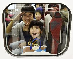 Father, son take test ride on Hokuriku Shinkansen train