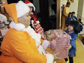 Konishiki visits quake-hit areas as Santa Claus