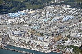Sprawling Fukushima nuke plant with piles of polluted waste stored