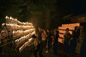 Well-wishers light candles at shrine in western Japan