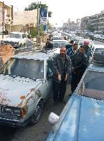 Long line of cars seen before filling station