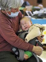 Baby and grandmother in evacuation center