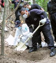 Investigators dig suspected mass grave in Malaysia