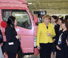 Merkel visits Daimler unit in Japan to see trucks for women