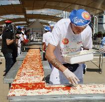 Chefs set Guinness record for longest pizza at Milan expo