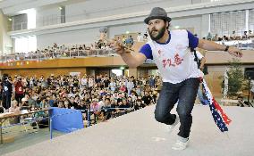 Man demonstrates tricks at cup-and-ball "kendama" world contest