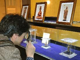 Buddha figurines labeled as important cultural assets on display