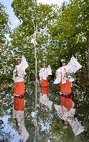 Schoolgirls dance in Shinto costumes at north Japan shrine