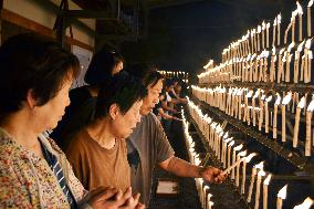 Well-wishers light candles at shrine in western Japan