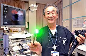 Physician Uemura poses with endoscope