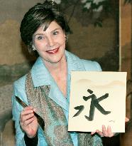 First Lady tries calligraphy in Kyoto