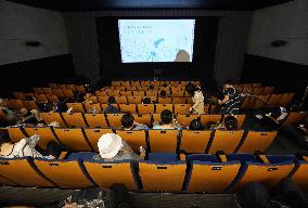 Japan eases virus rule to allow more people at sports, movie venues