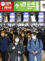 Japan to extend virus emergency to March 7 as hospitals strained