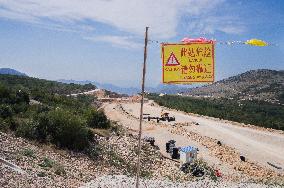 construction site of the Bar-Boljare motorway, highway, landscape, sign, warning CAUTION, DANGER,