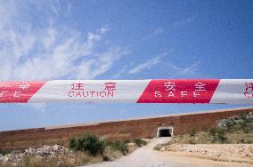 construction site of the Bar-Boljare motorway, highway, landscape, sign, warning CAUTION, SAFE, Chinese characters