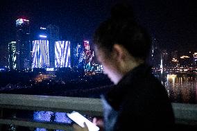 Asian girl, smart-phone, cityscape, Chongqing, China