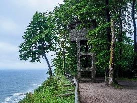 Watchtower and a tree over frothy turbulent sea