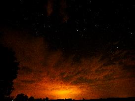 Red cloudiness, horizon, stars on the sky