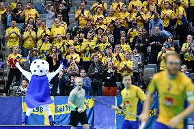 A mascot and a cheerleader cheer visitors