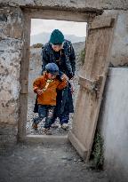 Ladakhi boy, Ladakhi old woman, traditional dress, Ladakh, Kashmir, India