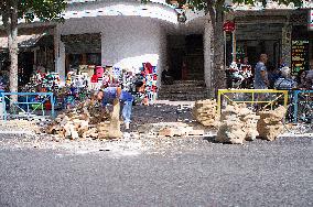 Korce (Korca) town, a man picks up chopped wood