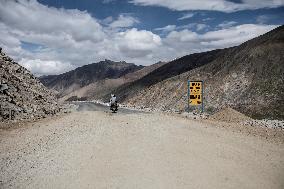 Mountain road, motorcycle, road sign, Himalayas, Ladakh, Kashmir, India