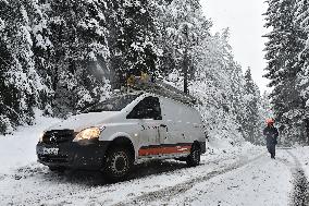 Road leading up to the Jetrichovice, snowfall, wind, snow, falling trees, workers