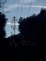Masts, power lines, forest, hillside