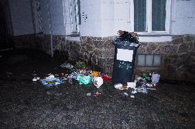 overfilled garbage plastic bin, assorted waste, rubbish