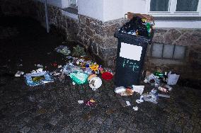 overfilled garbage plastic bin, assorted waste, rubbish