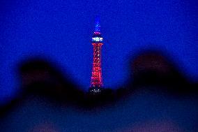 The lookout tower on Petrin hill lit in the French national colours