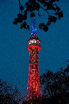 The lookout tower on Petrin hill lit in the French national colours