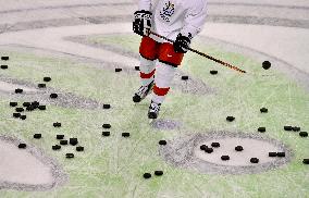 Unidentified Czech player and a flock of pucks