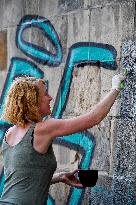 removal graffiti from sprayed pillar of Prague's historical Charles Bridge