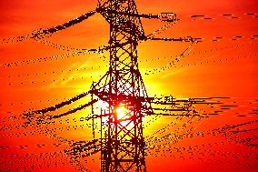 Transmission towers, high voltage pylon, sunset, CEZ, Czech Republic