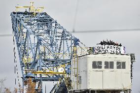 activists block coal mine excavator in protest of mine sale