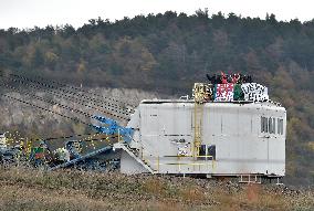 activists block coal mine excavator in protest of mine sale