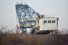 anti-coal power activists occupying excavator for third day