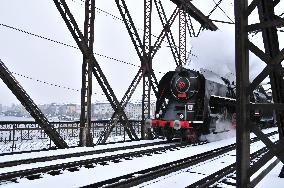 Steam locomotive Skoda 475.179 nickname Slechticna (Noblewoman) on Vysehrad railway bridge over the Vltava River