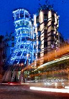 the Dancing House lit in the turquoise colour of the UNICEF