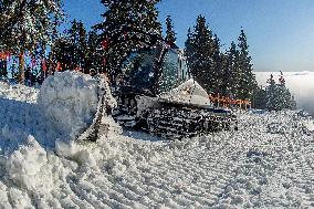 snowcat moves snow in ski resort