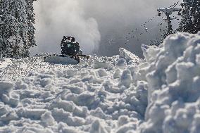 snowcat moves snow in ski resort