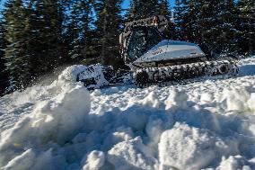 snowcat moves snow in ski resort