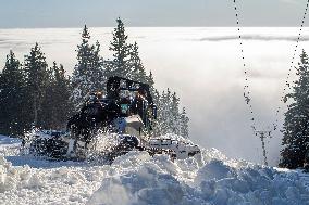 snowcat moves snow in ski resort