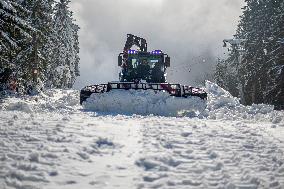 snowcat moves snow in ski resort