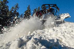 snowcat moves snow in ski resort